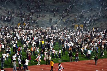 Egyptians Zamalek fans try to attack the referees and players of Tunisia African club after they stormed the pitch during their second round soccer qualifying match of the African Champions League (CAF) in Cairo, Egypt 02 April 2011.