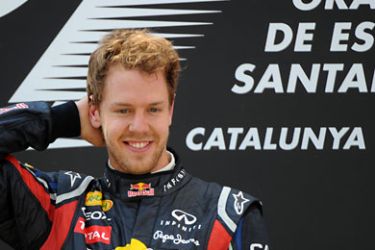 afp-Red Bull Racing's German driver Sebastian Vettel celebrates winning on the podium at the Circuit de Catalunya