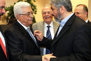 Palestinian president Mahmud Abbas (L) shaking hands with Hamas leader Khaled Meshaal (R) in Cairo on May 4, 2011 during a reconciliation ceremony