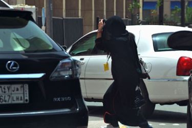 A Saudi woman walks past cars in Riyadh on May 26, 2011 as a campaign was launched on Facebook calling for men to beat Saudi women who drive their cars in a planned protest next month against the ultra-conservative kingdom's ban on women taking the wheel.
