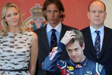 afp-Red Bull Racing's German driver Sebastian Vettel (DOWN) celebrates on the podium as Prince Albert of Monaco