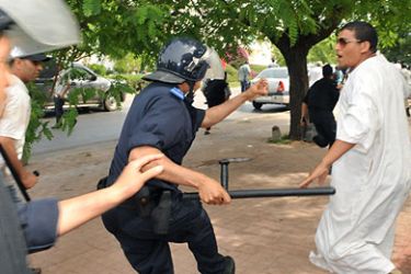 Police officers clash with members of the so-called "February 20 movement", during a protest calling for political reforms in Morrocco, in Rabat, on May 15, 2011. Ten people were injured today after the police broke up a rally to prevent protesters to reach a detention centre. AFP PHOTO/ ABDELHAK SENNA
