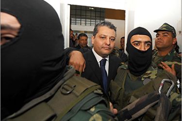 This file photo taken on April 20, 2011 shows Imed Trabelsi (C), the nephew of Leila Ben Ali, wife of former Tunisian President Zine el Abidine Ben Ali arriving at court, surrounded by military security, to face drug charges, at The Palace of Justice, in Tunis. Trabelsi was sentenced to two years in jail for using drugs, on May 7, 2011