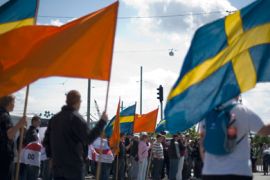 Members of the right-wing hold Swedish flags as they protest against a new mosque at Keillers Park in Gothenburg, southwest Sweden, on May 21, 2011.