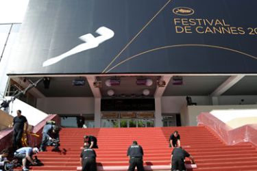 epa02726865 Workers prepare the red carpet in front of the Festival Palace on the opening day of the 64th Cannes