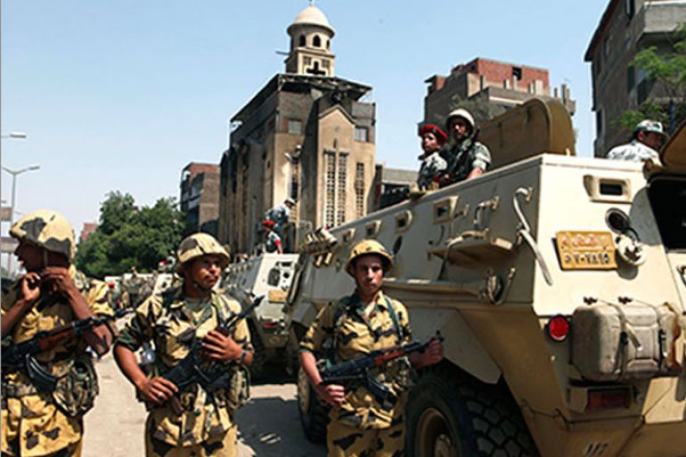 Soldiers stand guard near the Saint Mary church which was set on fire during clashes between Muslims and Christians on Saturday in the heavily populated area of Imbaba in Cairo May 8, 2011. Egypt's prime minister called an emergency cabinet meeting on Sunday after 10 people died in bloody clashes in a Cairo suburb over the conversion of a Christian woman to Islam.