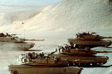 FILE PHOTO: M-1A1 Abrams main battle tanks test their guns prior to taking part in an exercise during Operation Desert Shield. (photo by DOD)