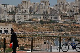 A man stands on a street in the West Bank Jewish settlement of Modiin Illit May 23, 2011. U.S. President Barack Obama on Sunday eased Israeli anger over his new Middle East peace proposals when he made it clear that the Jewish state would likely be able to negotiate keeping some settlements