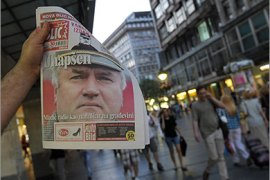A street vendor displays tomorrow's Serbian newspaper with the headlines about Ratko Mladic's arrest in Belgrade on May 26, 2011. Serbia today announced the arrest of former Bosnian Serb military chief Ratko Mladic, ending a 16-year manhunt for the general accused of masterminding the Srebrenica massacre,