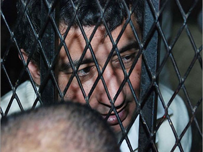 epa02597550 Ahmed Ezz, the former parliament member and leading figure of the National Democratic Party of ousted president Hosni Mubarak, appears behind bars at a court in Cairo, Egypt, on 23 February 2011.