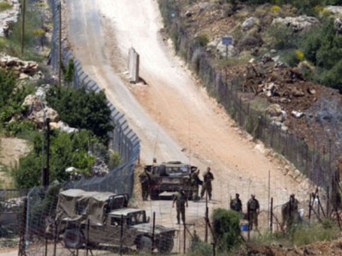 Israeli soldiers patrol along the border fence between the Israeli-annexed Golan Heights and Syria next to the Druze village of Majdal Shams on June 03, 2011, as Israel boosted security in the Golan Heights, sending troops and police to the northern region and denying access to non-residents amid fears that protesters could repeat May 15 demonstrations that saw dozens breach a security fence and enter from Syria.