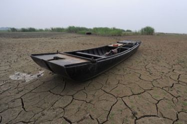 A fishing boat lies on the dried up bank of the Chaohu lake, the fifth largest freshwater lake in China, as water levels remain low in Chaohu, east China's Anhui province on June 4, 2011. Water levels in lakes and reservoirs mostly in the provinces of Jiangsu, Anhui, Jiangxi, Hubei and Hunan are close to historic lows, decimating fish farms, and so far has led to direct economic losses amounting to 14.94 billion yuan (USD2.29 billion), state press reports reported.