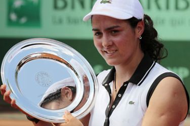 afp-Tunisia's Ons Jabeur holds the trophy after winning over Peurto Rico's Monica Puig during their Girls's Singles