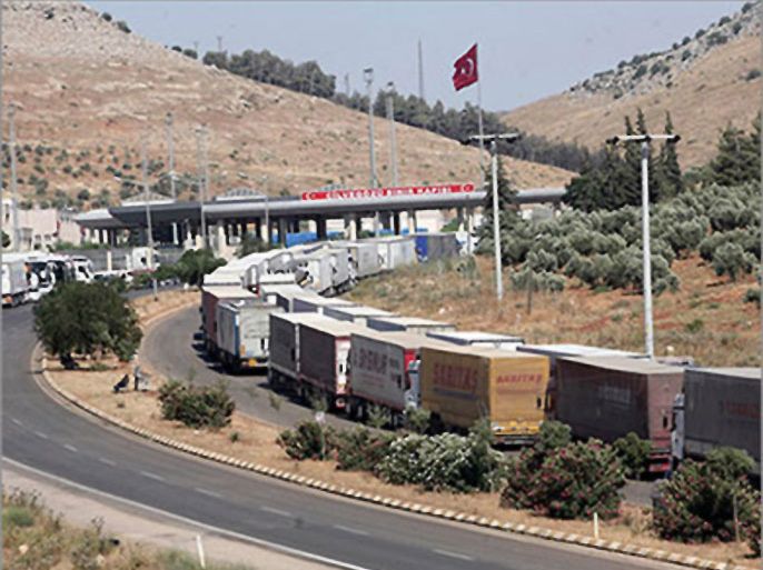 Turkish trucks wait on June 25, 2011 at the southern Turkish border crossing of Cilvegozu to enter Syria. Turkish truck drivers say Syrian authorities and part of the population are being hostile toward them since Turkey opened its border to Syrian refugees escaping the unrest in their country. Almost 12,000 Syrian refugees are sheltering in camps in the Turkish border province of Hatay
