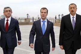 Kazan, -, RUSSIAN FEDERATION : Russian President Dmitry Medvedev (C), his Armenian counterpart Serzh Sarkisian (L) and Azerbaijan's President Ilham Aliyev (R) walk during their meeting in Kazan on June 24, 2011