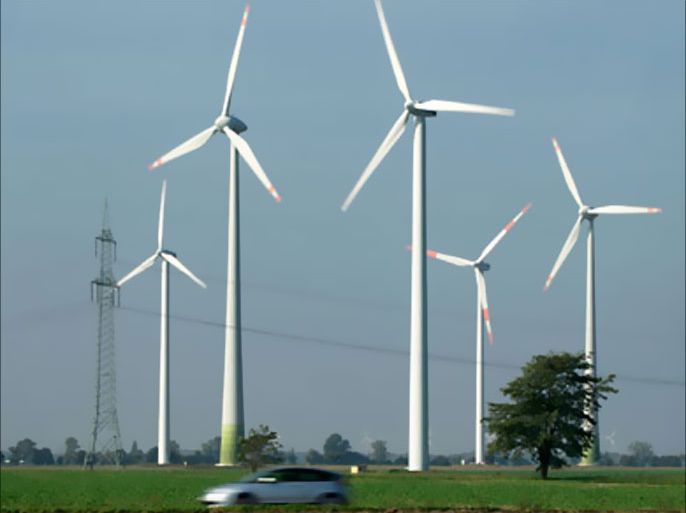 BITTERFELD, GERMANY - OCTOBER 06: A hybrid car drives past spinning wind turbines at a wind park on October 6, 2010 near Bitterfeld, Germany. The German government recently set ambitious goals for renewable energy sources in a new energy policy plan that calls for heavy investment in wind, solar and biogas electricity production. (Photo by Sean Gallup/Getty Images)