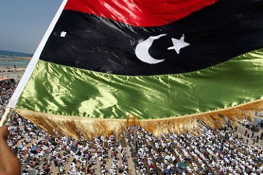 r_A Libyan waves a Kingdom of Libya flag during Friday prayers near the courthouse in Benghazi June 17, 2011. REUTERS