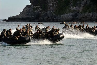 (FILES) File photo taken on October 11, 2010 shows US Marines and their Philippine counterparts approach a beach on rubber boats to secure a hill during joint military training exercises in Cavite, south of Manila. State-of-the-art US missile destroyers will join ageing Philippine warships for naval exercises this week in a timely show of unity as tensions with China escalate
