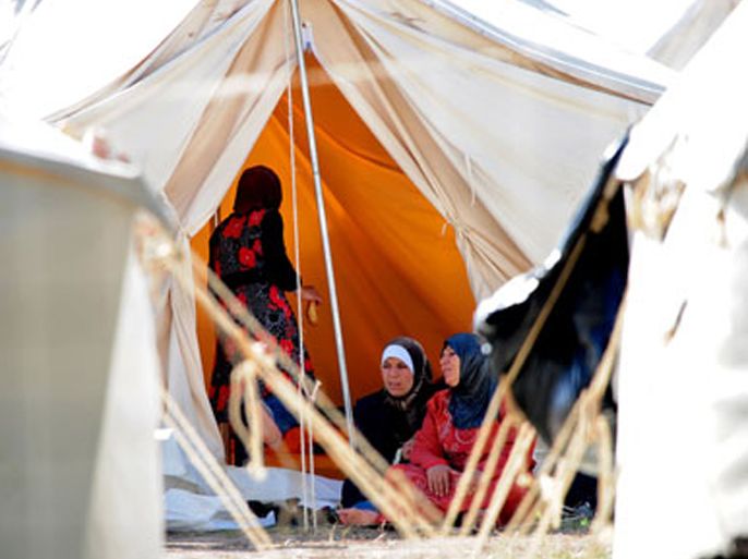 Syrian refugee women sit in front of their tent on June 9, 2011 at the Turkish Red Crescent camp in the Yayladagi district of Turkish city of Hatay, two kilometers from the Syrian border. The number of Syrians who have fled to Turkey fearing bloodshed in their country has increased by some 400 to 2,500.