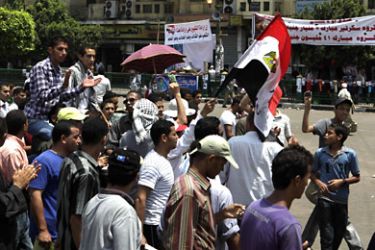 r_Protesters chant slogans against the government and military rulers in Tahrir square in Cairo July 11, 2011. Egyptian activists vowed on Sunday to stay camped in Cairo's Tahrir Square, accusing the army rulers of failing to sweep out corruption, end the use of military courts and swiftly try those who killed protesters. REUTERS