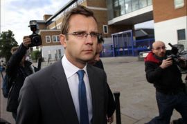 Andy Coulson, former editor of The News of the World, is confronted by the media as he leaves Lewisham police station in London on July 8, 2011