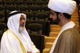 f_Bahraini Parliament Speaker Khalifa Dhahrani (L) shakes hands with a Shiite cleric at the opening of the Gulf state's national dialogue meeting in Manama on July 2, 2011