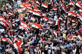 A handout picture released by the Syrian Arab News Agency (SANA) shows thousands of Syrians waving national flags during a rally in support President Bashar al-Assad in the Damascus Christian neighbourhood