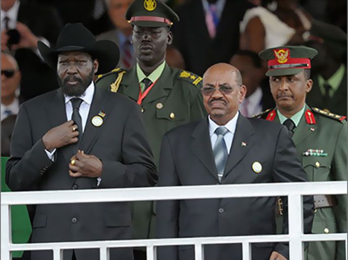 The president of the Rebublic of South Sudan Salva Kiir (L) stands next to the President of Sudan Omar al Bashir (R) as they listen to the new national anthem of South Sudan during a ceremony in the capital Juba on July 09, 2011. South Sudan separated from Sudan to become the world's newest 193rd nation. AFP PHOTO/Roberto SCHMIDT