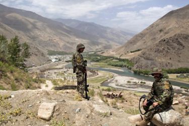 r_Afghan National Army soldiers keep watch along a road during a security handover ceremony in Panjshir province July 24, 2011