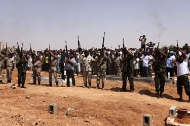 r_Rebel fighters attend the funeral of a colleague killed on the outskirts of Albriqa (West Ajdabiyah) by forces loyal to Libyan leader Muammar Gaddafi, in Benghazi July 22, 2011