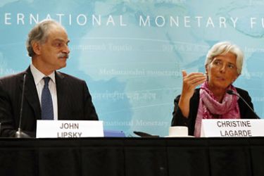 r_IMF managing director Christine Lagarde (R) holds a news briefing at the International Monetary Fund headquarters in Washington July 6, 2011
