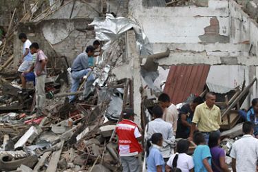 r_People surround a house that was damaged after being hit by a bus that detonated in Toribio, in Cauca province, July 9, 2011. Officials said the FARC rebel group staged three