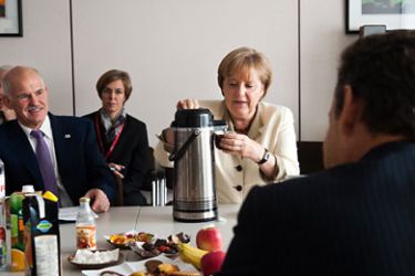 f_This handout photo made available by the German government press office shows (from L) Greek Prime Minister George A. Papandreou, German Chancellor Angela Merkel and French President Nicolas Sarkozy during a meeting at the EU summit