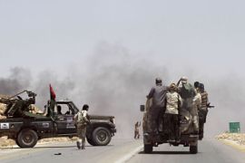 r_Rebel fighters enter the village of Al-Qawalish, after a battle to seize control of the town from forces loyal to Libya's leader Muammar Gaddafi, July 6, 2011