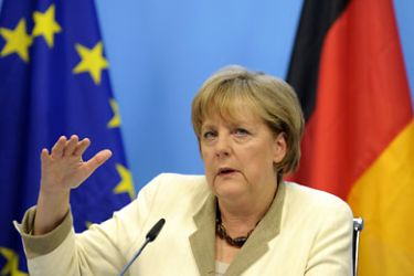 r_Germany's Chancellor Angela Merkel speaks during a news conference at the European Council building at the end of an euro zone leaders crisis summit in Brussels July 21, 2011