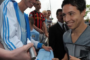 afp-French footballer Samir Nasri signs autographs as he is greeted by fans outside Manchester City's Etihad Stadium