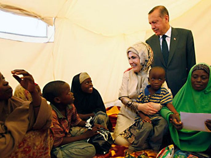 Turkey's Prime Minister Recep Tayyip Erdogan (top) and his wife Emine Erdogan visit a camp for displaced people in Mogadishu August 19, 2011.