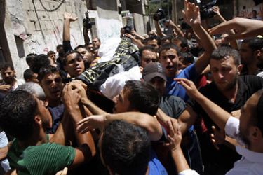 Palestinian mourners carry the body of Ismael al-Ismar, 34, during his funeral at Rafah town in the southern Gaza Strip, on August 24, 2011. The Palestinian man was killed in an Israeli air strike in the Gaza Strip, scarcely 48 hours after militant factions had agreed to a temporary ceasefire