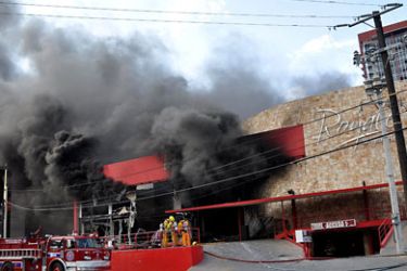 f_Thick smoke billows from the Casino Royale as firefighters attack the fire, in Monterrey, Mexico on August 25, 2011. 23 people were killed and 10 more were injured on Thursday as a result of an attack with at least an explosive device at the casino.
