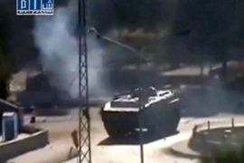 r_Smoke is seen near a tank at Al-Bahra roundabout in Hama in this still image taken from video made available on August 3, 2011. Syrian tanks occupied the main square in central Hama