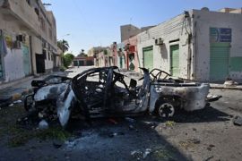 r_A destroyed vehicle sits on the side of the road after Libyan rebel fighters pushed pro-Gaddafi forces out of the center of the strategic coastal city of Zawiyah, August 20, 2011