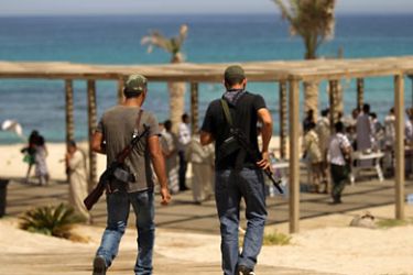 afp-Libyan rebels patrol the Regata Beach resort in Tripoli as locals celebrated outdoors