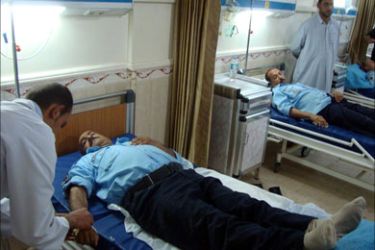 epa02867524 Iraqi policemen receive medical treatment at a local hospital after they were injured in a car bomb attack in Najaf, southern Iraq, on 15 August 2011.