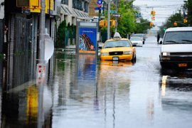A taxi sits in flood water on Coney Island after Hurricane Irene hit, in New York, August 28, 2011. The death toll from Irene has risen to 12 across five eastern US states, emergency officials said Sunday, as the hurricane was downgraded to a tropical storm, passing New York City. AFP