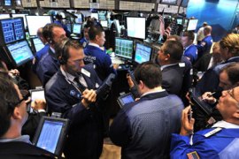 Traders crowd around a post on the floor of the New York Stock Exchange at the opening bell August 9, 2011. US stocks surged more than one percent on opening Tuesday following Monday's plunge, but within minutes the gains fell off on profit-taking.