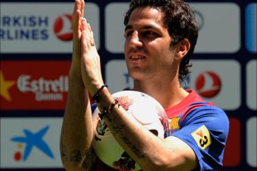 Barcelona's new player Cesc Fabregas applauds during his official presentation at the Camp Nou's stadium in Barcelona, after signing a new contract with the Catalan club, on August 15, 2011