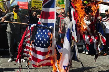 Turkish Muslim demonstrators burn Britain, US and Israeli flags during a protest in front of Beyazit Mosque after the Friday prayer in Istanbul on August 26, 2011