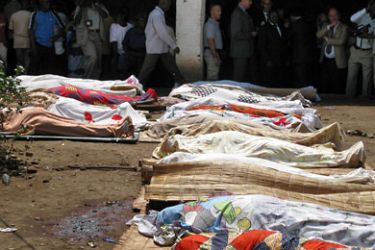 : Bodies of victims of armed raiders covered-over with cloth are lined-up for identification on September 19, 2011 in the capital Bujumbura.