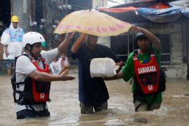 A resident carries a makeshift casket of his 1-day old baby as they evacuate their home due to rising floodwaters brought by Typhoon Nesat, locally known as Pedring in San Mateo Rizal east of Manila September 27, 2011.