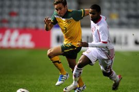 afp-James Brown of Australia runs for the ball with Abdelaziz Mohamed of the United Arab Emirates